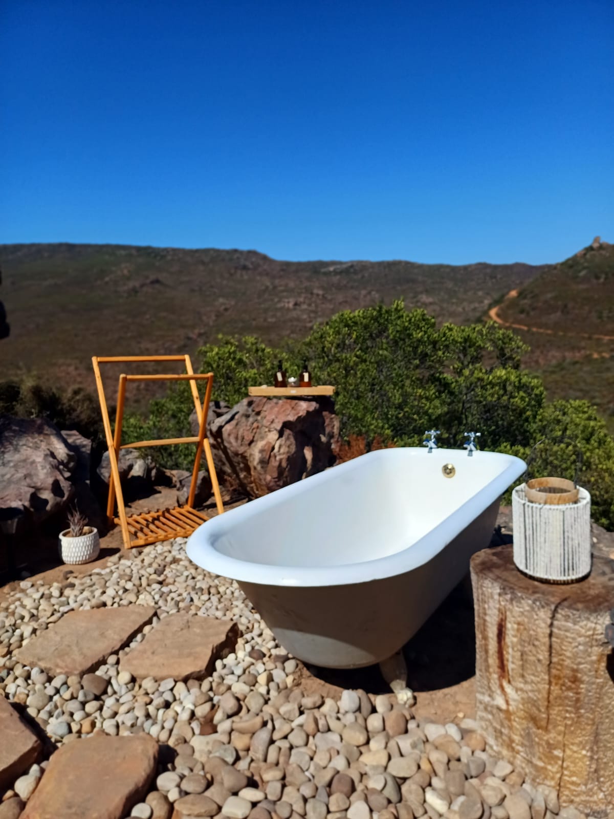 Cliffside bathtub with mountain panorama
